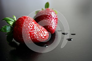 Two fresh wet strawberries