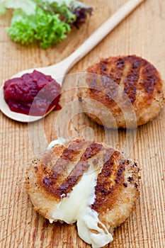 Two fried camembert cheeses in bread crumbs photo