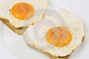 Two Fried Eggs with Salt and Pepper on Toast
