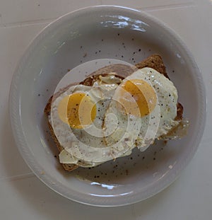 Two fried eggs on wholemeal toast.