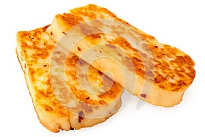 Two fried slices of halloumi cheese with red chilli isolated on white