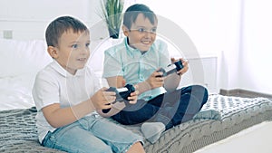 Two friends or brothers smiling and having fun playing a video game with controllers