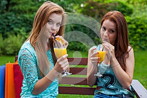 Two friends drink refreshing, cold orange juice.
