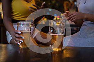 Two friends drinking beer. Detail shot of beer glasses