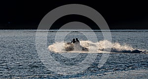 Two friends enjoying the jet ski skidding at high speed on Boiro beach