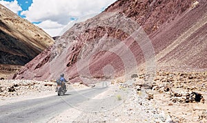 Two friends go by motorcycle by the Leh - Manali highway in high Himalayas Mountain, India