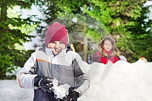 Two friends having snowball fight