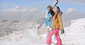 Two friends hiking up ski slope