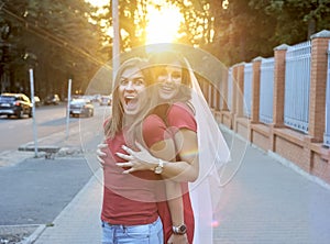 Two friends hugging outside