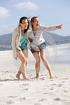 Two friends laughing and enjoying life at the beach