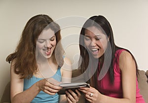 Two friends laughing at photographs