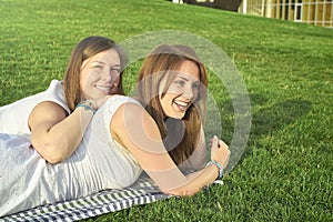 Two friends lying on the lawn