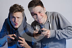 Two friends making funny faces while playing video games