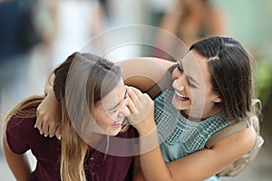 Two friends meeting and joking on the street