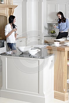 Two friends relaxing in the kitchen