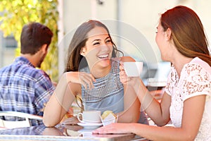 Two friends or sisters talking taking a conversation in a bar photo