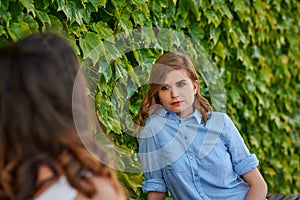 Two friends talking in a park photo