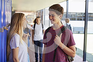 Two friends talking in school corridor at break time