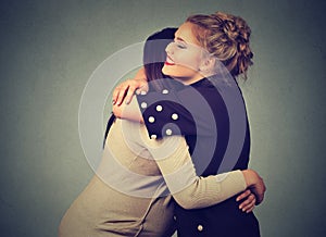 Two friends women hugging photo