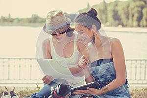 Two friends women outdoors studying and looking happy