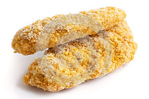 Two frozen bread crumbed chicken strips.