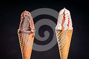 Two frozen ice cream flavors in sugar cones