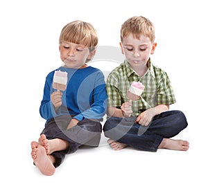 Two funny boys eating ice lolly