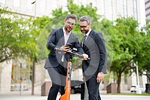 Two funny businessmen discussing outdoor. Two business people talk project strategy. Two american businessmen in suits