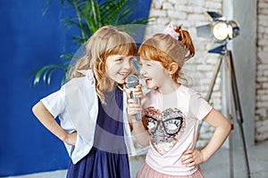 Two funny children sing a song in karaoke. The concept is childh photo