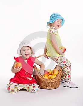 Two funny girls with apple harvest