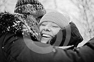 Two funny girls friends having fun at winter snowy day near snow covered trees