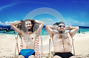 Two funny guys resting on the beach