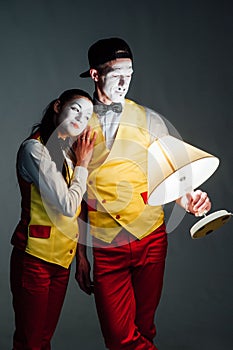 Two funny mimes isolated on gray background