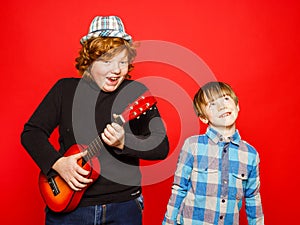 Two funny red-hair brothers playing music