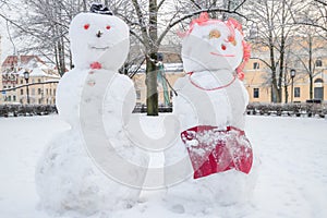 Two funny snow figures - a snowman and a woman