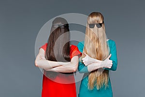Two funny women covered face with long hair