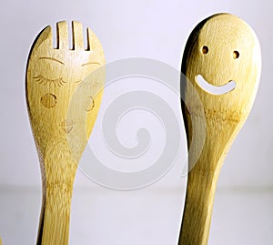 Two funny wooden spoons with human characteristics