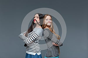 Two funny young women making moustache with their hair