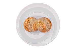 Two fused-glass cookies on a white saucer