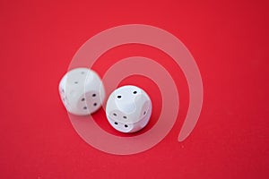 Two game dices, two white tiles on red background