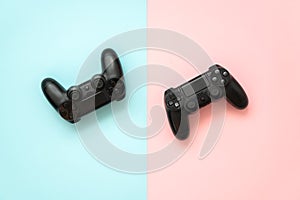 Two game joystick from the set-top box on a blue and pink background. The concept of games for boys and girls