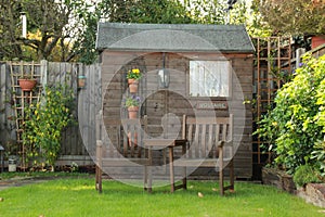 Two garden chairs and garden shed on a sunny day