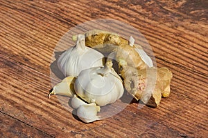 Two garlic bulbs and funnels with ginger root for health and organic medical care