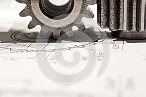 Two gears after manufacturing on a CNC machine are on the drawing, close-up