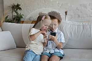 Two gen Z sibling children using app on mobile phone