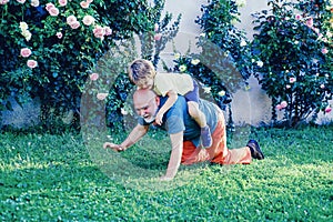 Two generation - weekend together. Happy father and son on meadow in summer. Grandfather and grandson Playing - Family