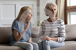 Two generations family elderly mother and young daughter having conflict