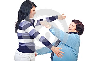 Two generations of women prepare to hug photo