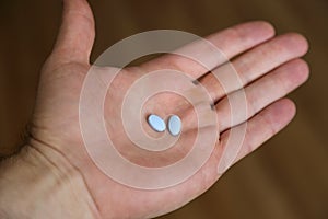 Two Generic Naproxen Sodium Tablets are Shown in a Hand