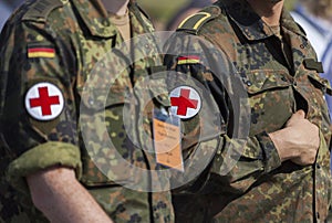 two german army soldiers with a red cross brassard